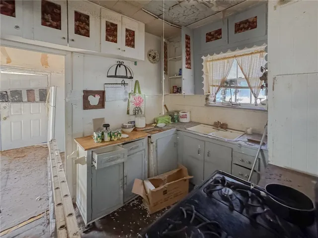 a room with a sink and cabinets