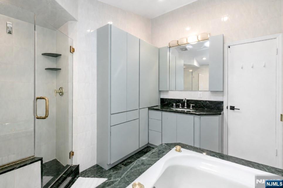 433 Piermont Road Cresskill, NJ 07626 - Photo 27 of 49 a bathroom with a shower and a sink