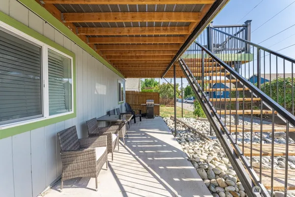 a view of balcony with wooden floor and seating space