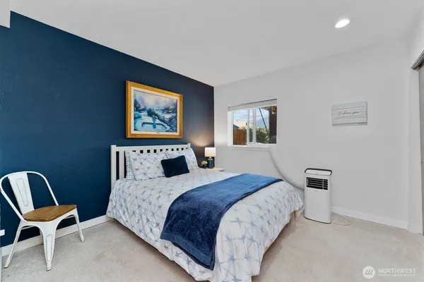 a bedroom with a bed and chair