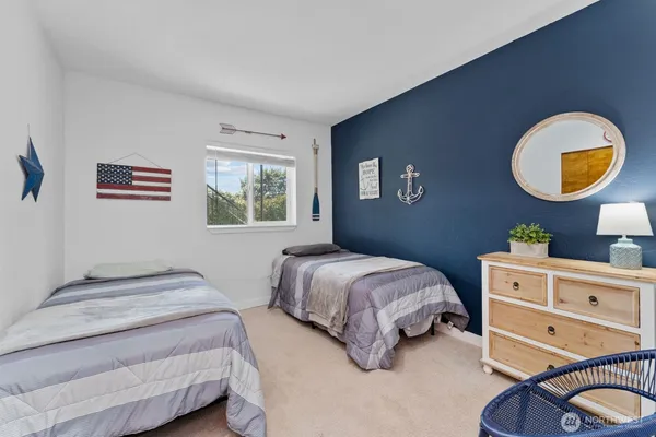 a bedroom with a bed and painting on the wall