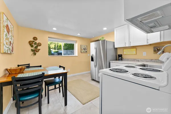 a kitchen that has a table and chairs in it