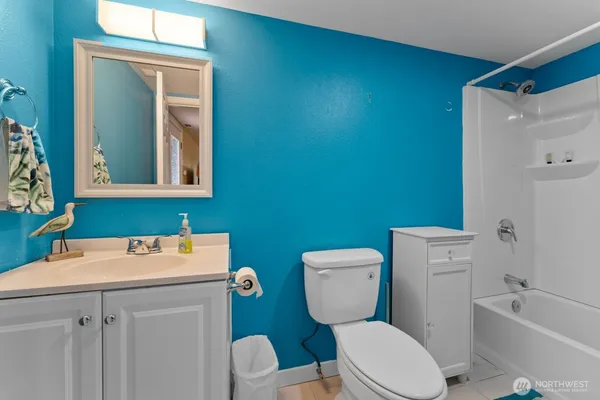 a white toilet sitting next to a bathroom sink