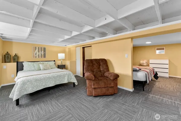 a spacious bedroom with a bed and a couch