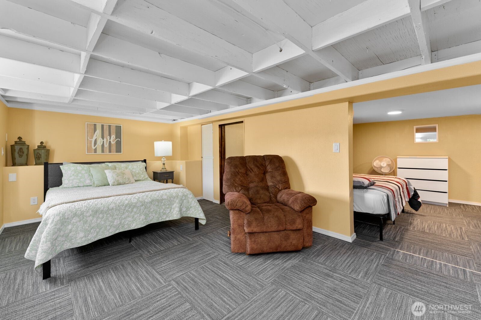 703 Boetzke Avenue Manson, WA 98831 - Photo 28 of 40 a spacious bedroom with a bed and a couch