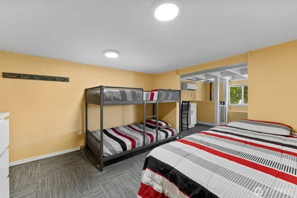 a bedroom with two beds and a dresser