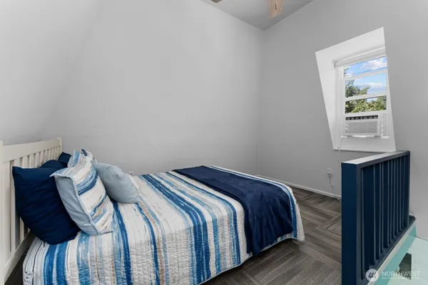 a bed sitting in a bedroom next to a window