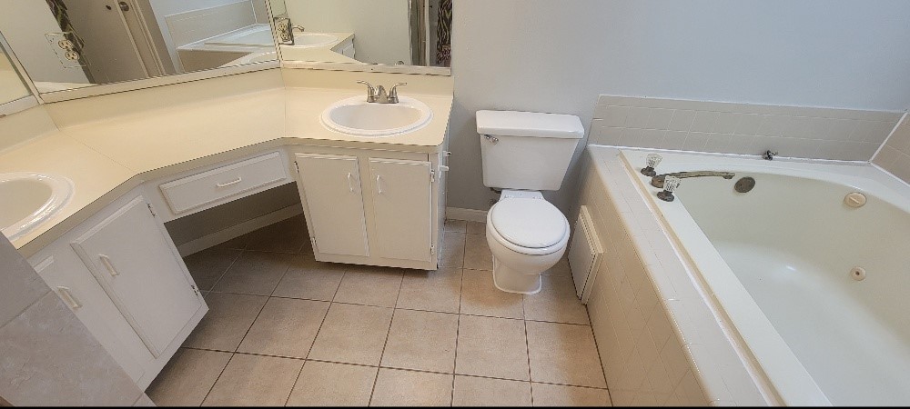 7023 Alabonson Road Houston, TX 77088 - Photo 11 of 13 a bathroom with a sink and a washing machine
