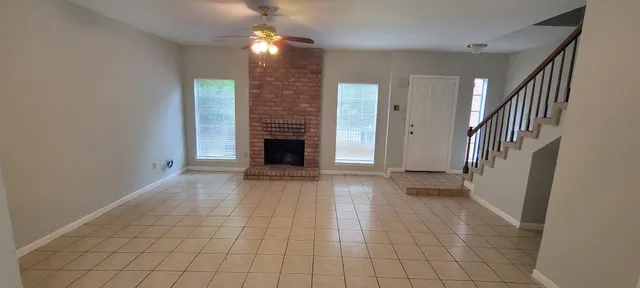 a view of entryway and hall with a fireplace