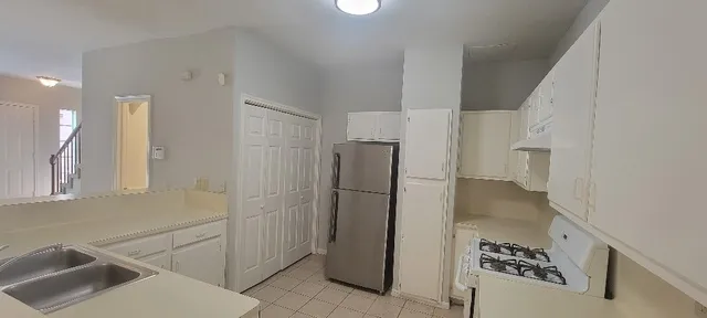 a kitchen with a refrigerator and a sink