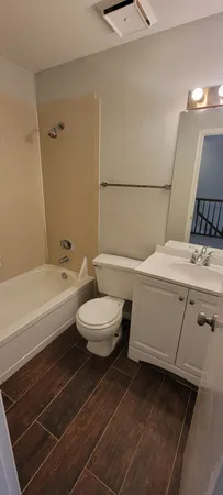 a bathroom with a toilet a sink and bathtub