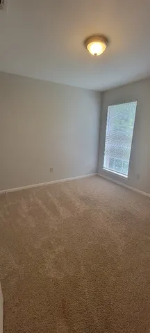 an empty room that has a mirror