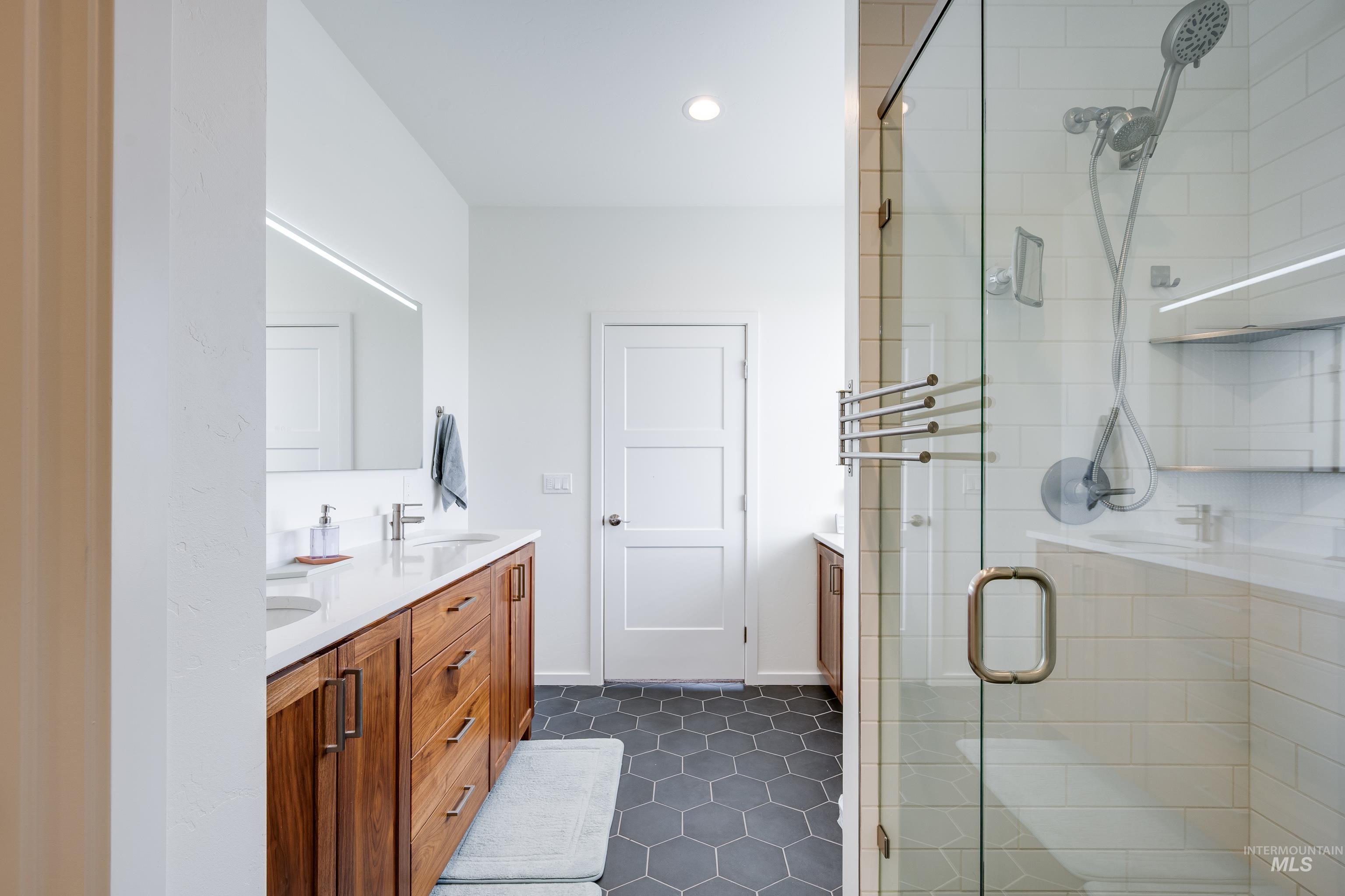 1325 Southwest Panorama Drive Pullman, WA 99163 - Photo 20 of 48 Full bath featuring double vanity, a stall shower, dark tile patterned floors, and recessed lighting