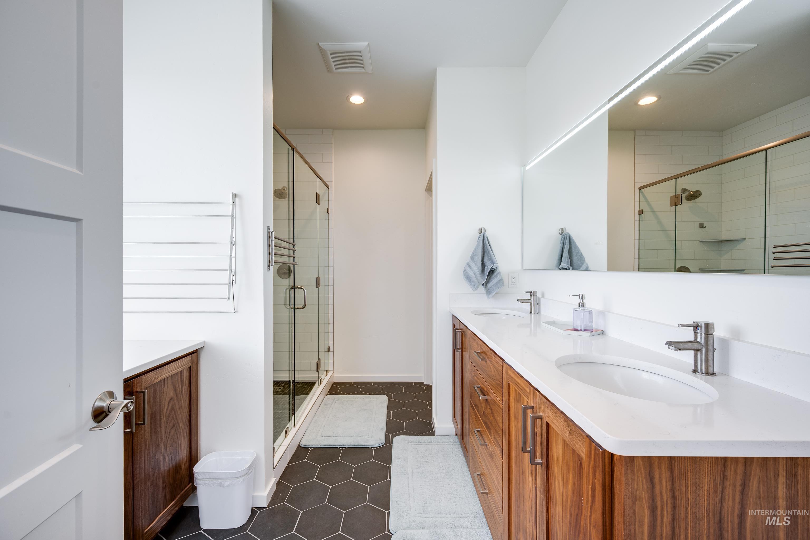 1325 Southwest Panorama Drive Pullman, WA 99163 - Photo 21 of 48 Bathroom featuring double vanity, a stall shower, dark tile patterned flooring, and recessed lighting