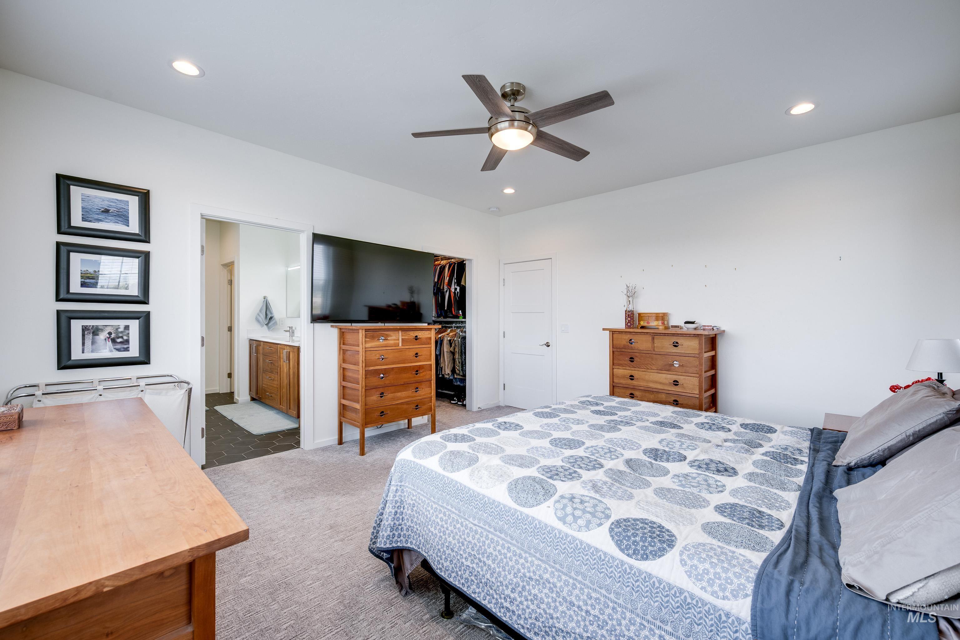 1325 Southwest Panorama Drive Pullman, WA 99163 - Photo 22 of 48 Carpeted bedroom featuring a ceiling fan, recessed lighting, a spacious closet, and ensuite bathroom