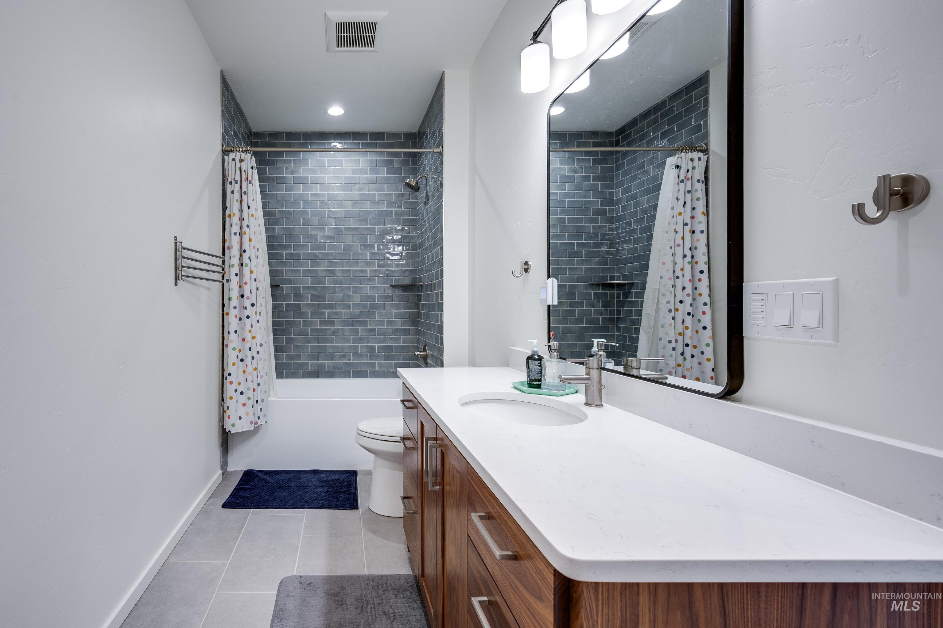 1325 Southwest Panorama Drive Pullman, WA 99163 - Photo 24 of 48 Full bathroom featuring light tile patterned floors, shower / bath combo with shower curtain, and vanity