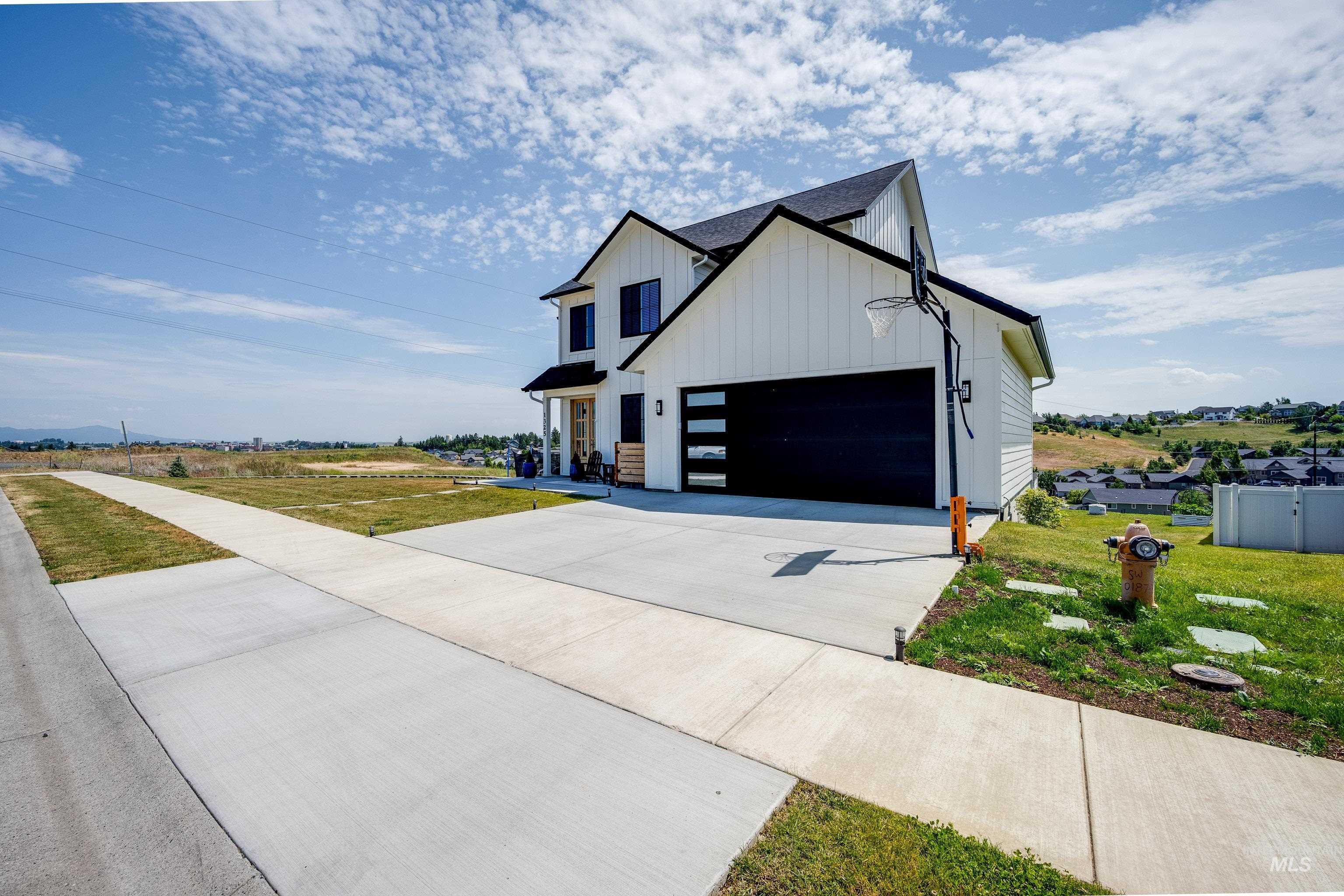 1325 Southwest Panorama Drive Pullman, WA 99163 - Photo 46 of 48 Modern farmhouse style home featuring board and batten siding, driveway, and a front lawn