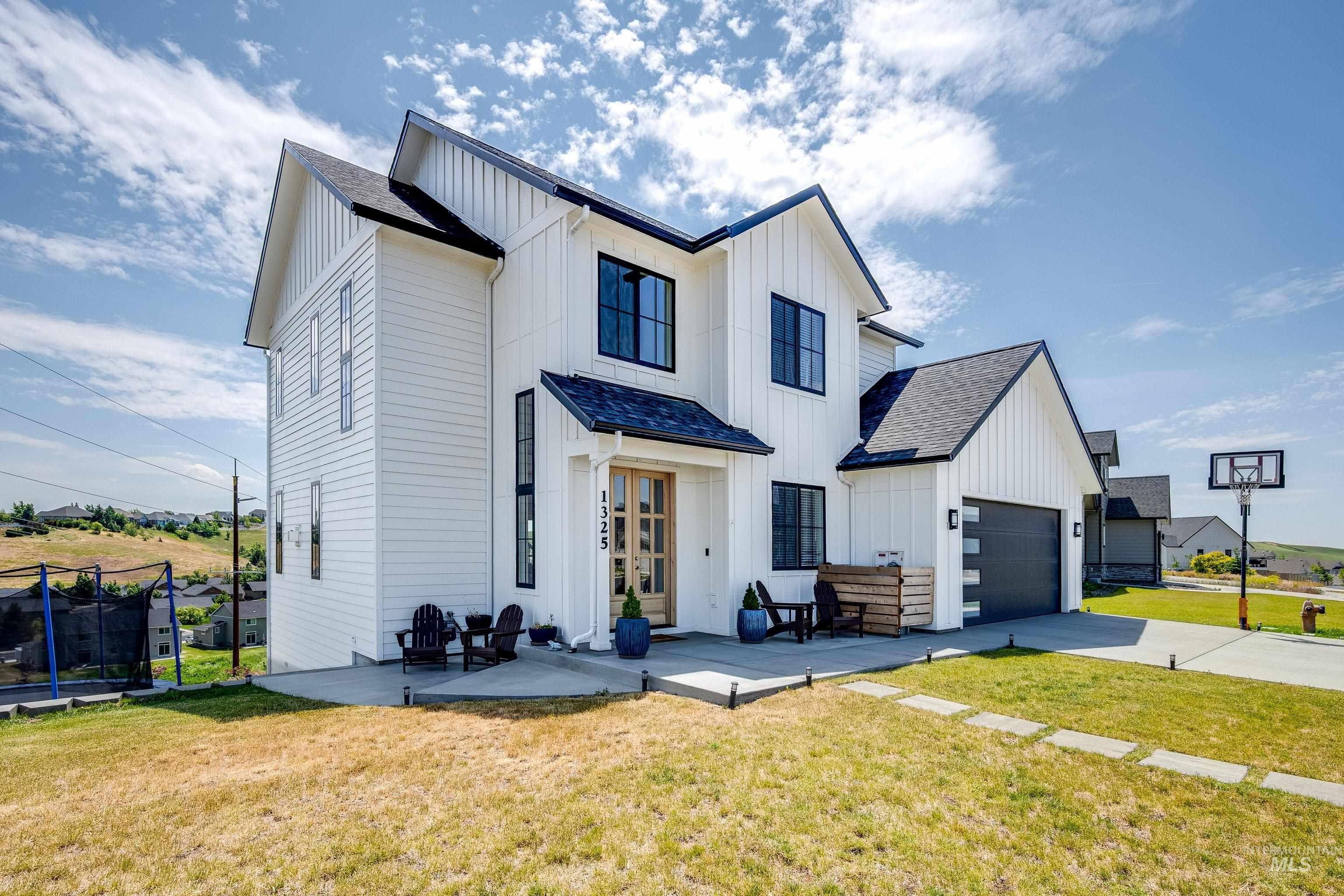 1325 Southwest Panorama Drive Pullman, WA 99163 - Photo 47 of 48 Modern inspired farmhouse featuring board and batten siding, a trampoline, concrete driveway, and a front yard