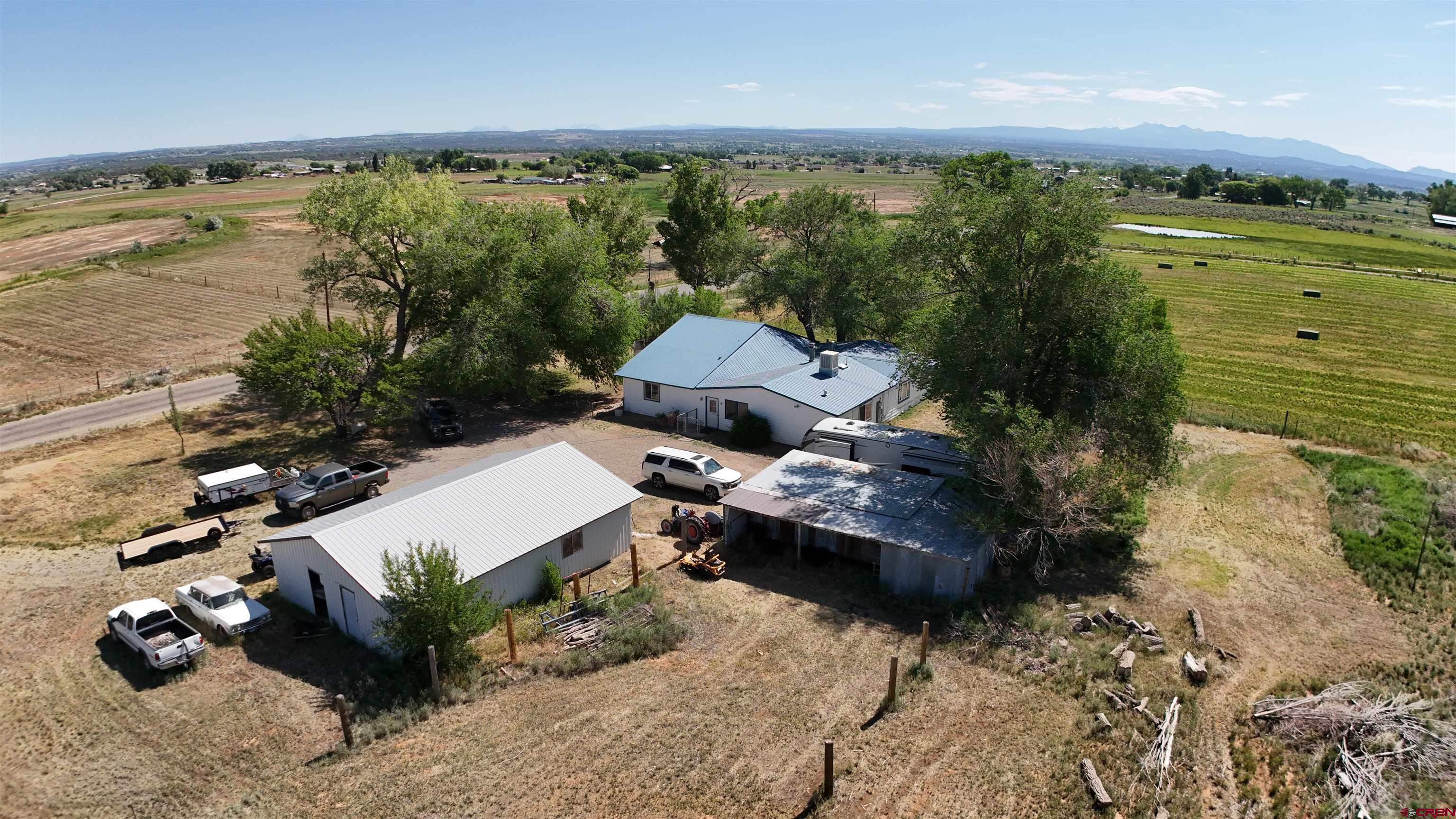 an aerial view of a house with a garden and lake view
