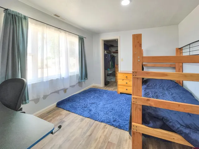 a bedroom with a bed and window