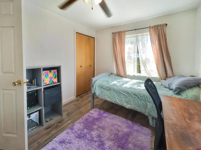 a bedroom with a bed and a television