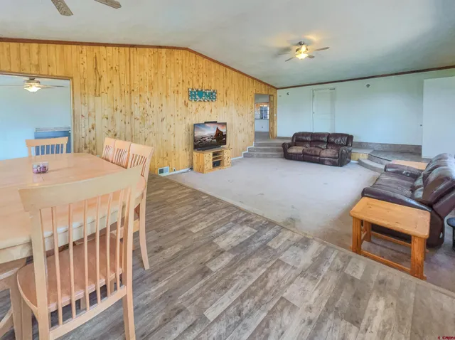 a living room with furniture a table and a large window