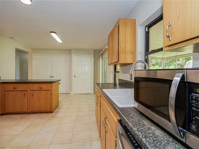 a kitchen with stainless steel appliances granite countertop a sink and a granite counter tops