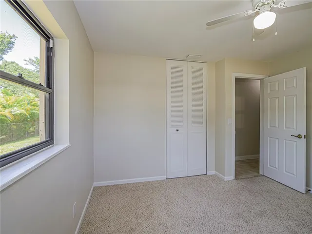 an empty room with windows and closet