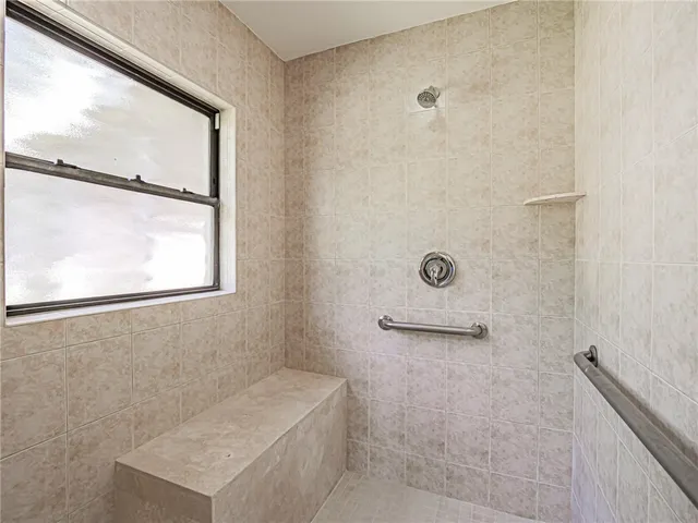 a bathroom with a shower and a window