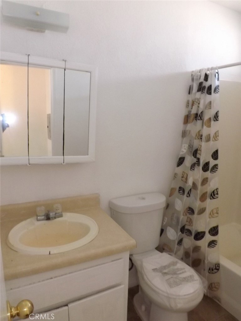 18202 Casaba Road, Unit B Adelanto, CA 92301 - Photo 29 of 32 a bathroom with a sink toilet and shower