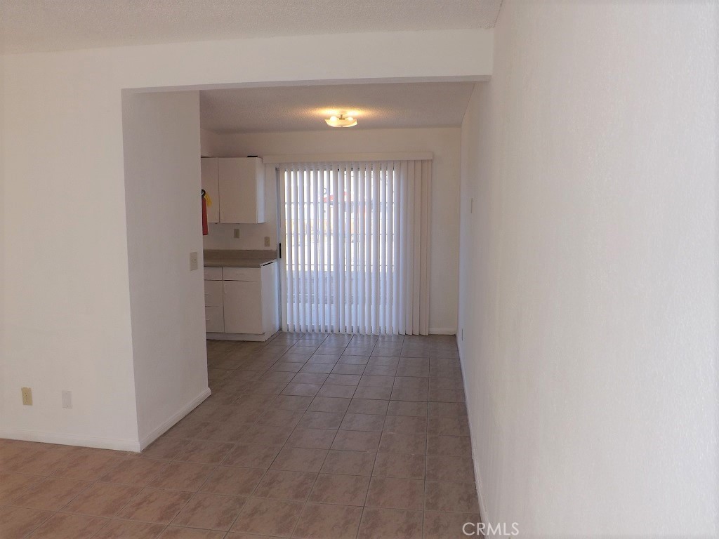 18202 Casaba Road, Unit B Adelanto, CA 92301 - Photo 9 of 32 a view of hallway with a sink and a refrigerator