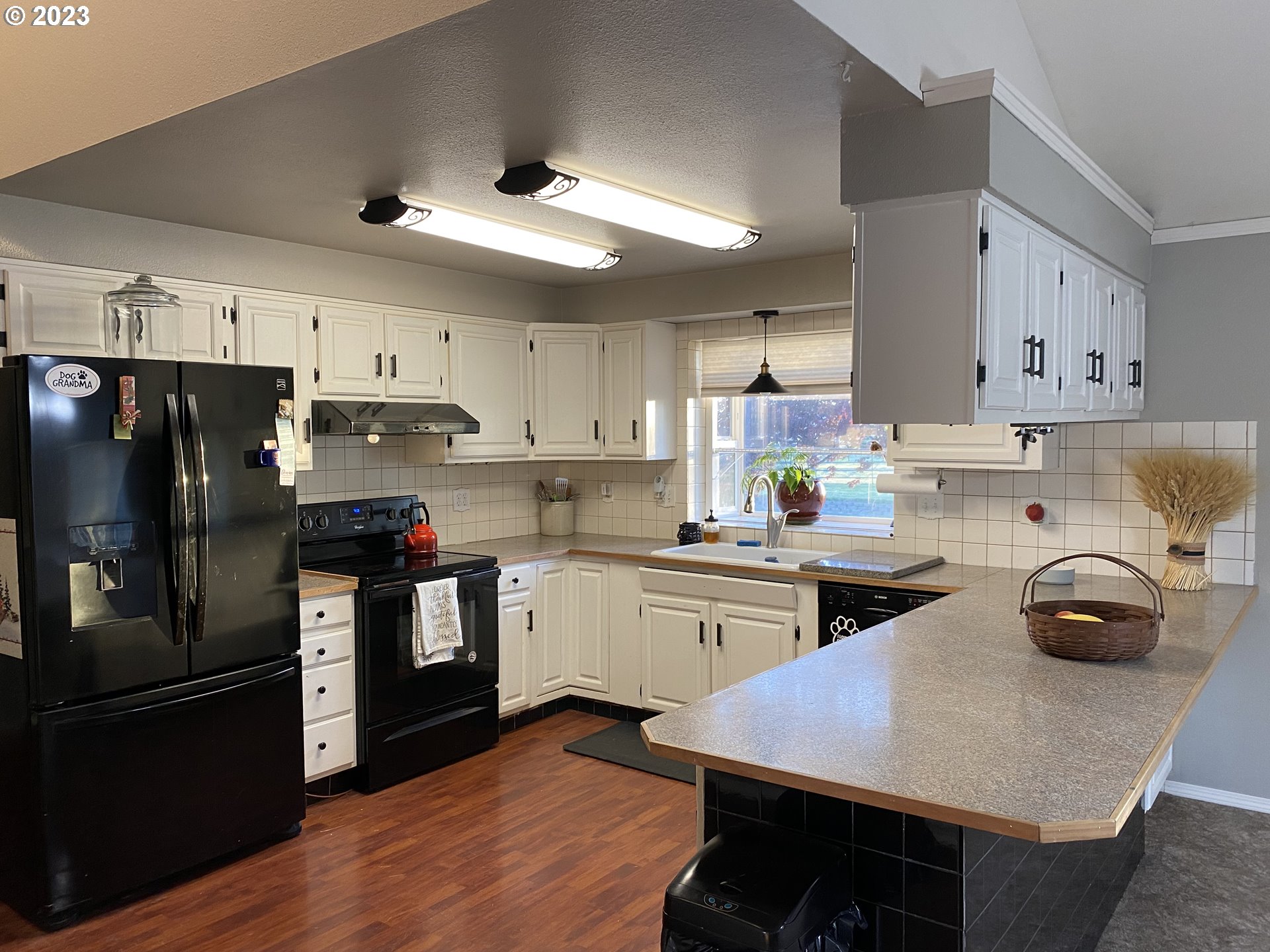 43776 Buckboard Trail Road Pendleton, OR 97801 - Photo 6 of 22 a kitchen with granite countertop a sink cabinets stainless steel appliances and a center island