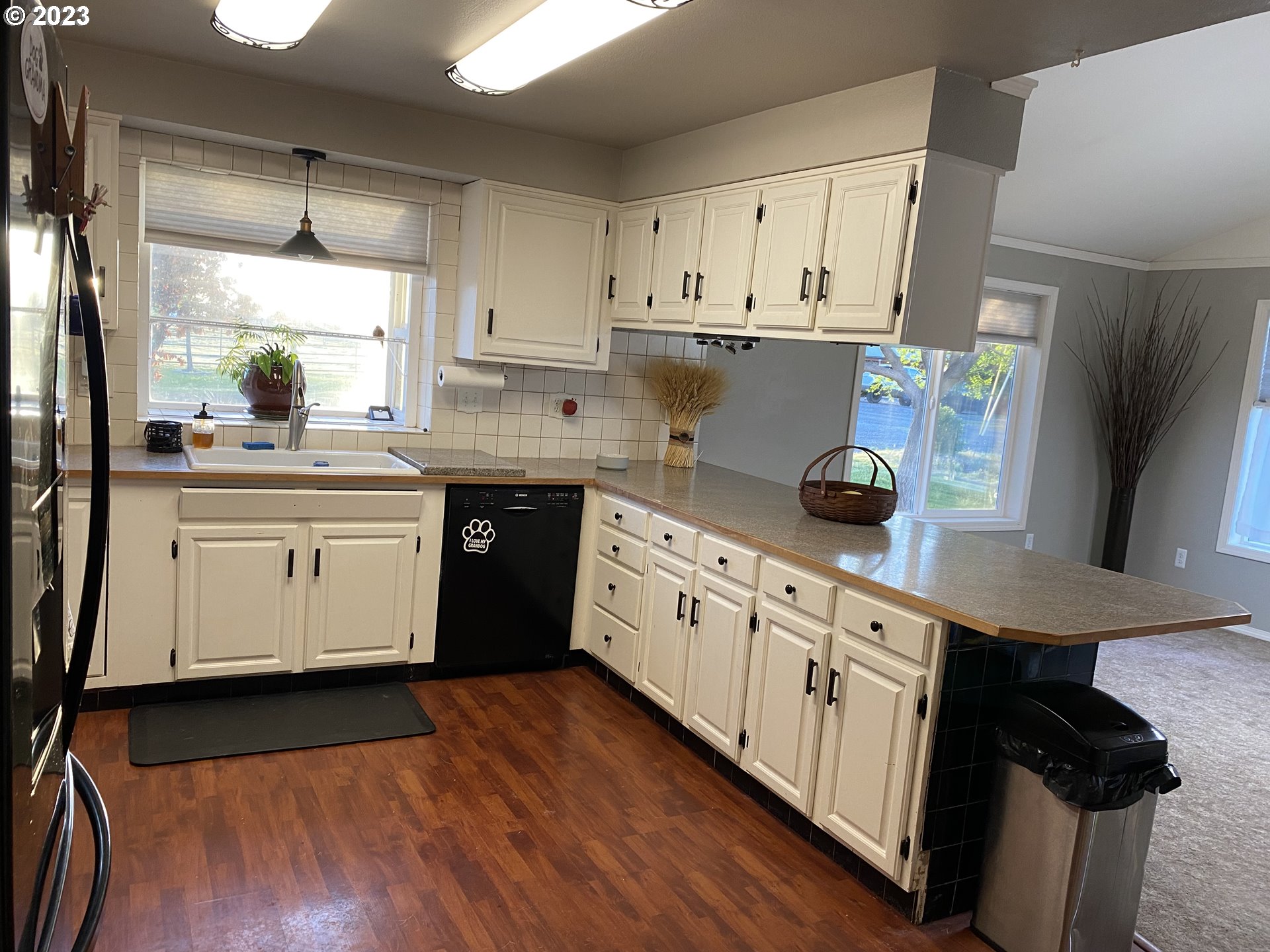 43776 Buckboard Trail Road Pendleton, OR 97801 - Photo 7 of 22 a kitchen with stainless steel appliances granite countertop white cabinets a sink a stove a refrigerator and island with wooden floor