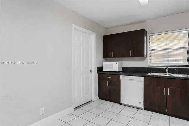 a kitchen with stainless steel appliances granite countertop a sink and a stove top oven