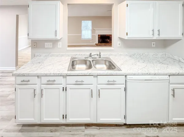 a kitchen with granite countertop a sink and a stove