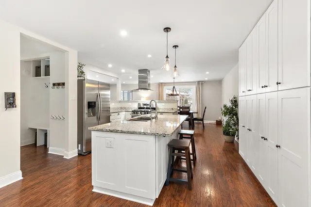a kitchen with stainless steel appliances kitchen island a island in the center and wooden floors