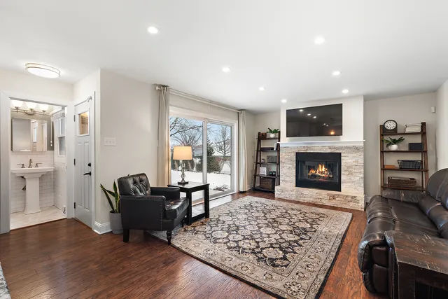 a living room with furniture rug and a fireplace