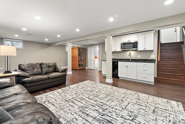 a living room with a couch and a kitchen view