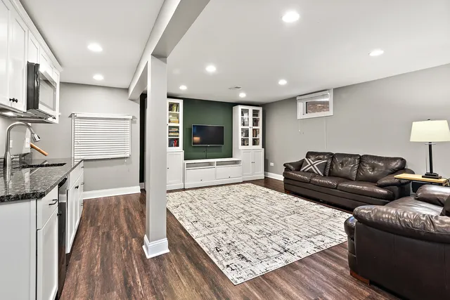 a living room with a couch and a wooden floor