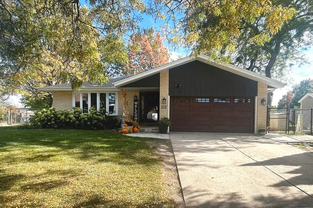 a house with lots of trees in the background