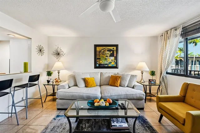a living room with furniture a rug and a large window