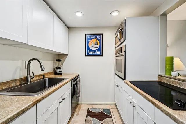 a kitchen with stainless steel appliances a sink a stove and a refrigerator