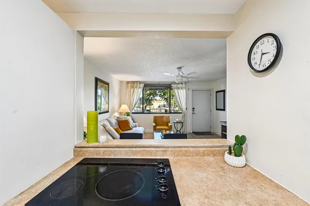 a view of dining room with kitchen island stainless steel appliances wooden floor and window