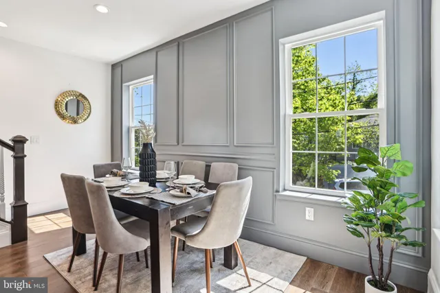 a view of a dining room with furniture window and wooden floor