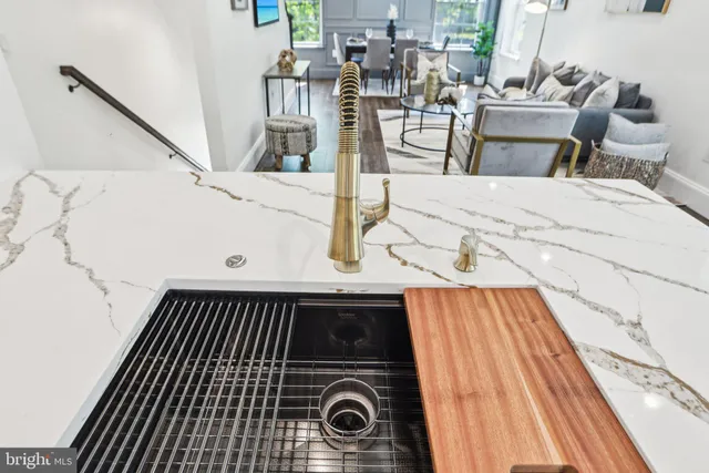 a kitchen with stainless steel appliances granite countertop a sink a stove and a microwave