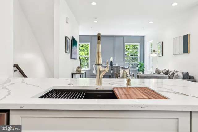 a kitchen with stainless steel appliances granite countertop a refrigerator and a stove