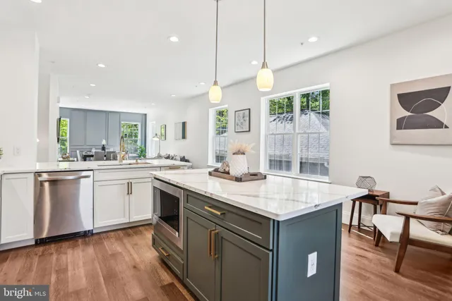 a kitchen with a dining table chairs and refrigerator