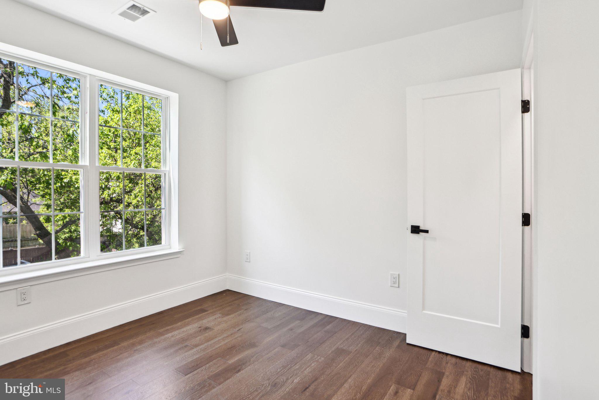 322 56th Street Northeast Washington, DC 20019 - Photo 31 of 57 an empty room with wooden floor and windows