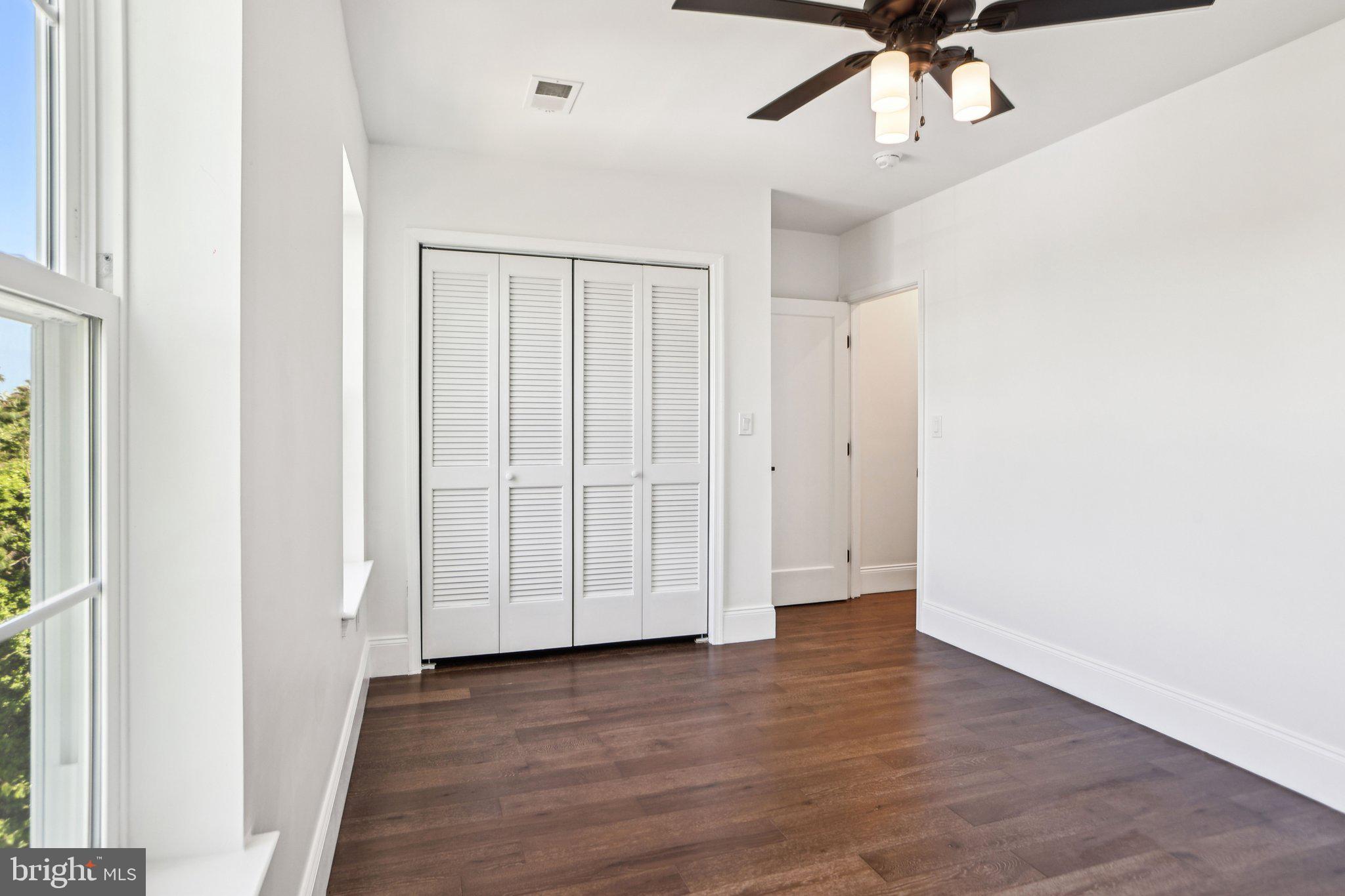 322 56th Street Northeast Washington, DC 20019 - Photo 36 of 57 an empty room with wooden floor fan and windows