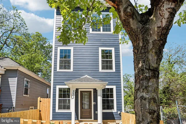 front view of a house with a tree